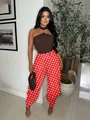 Stylish red polka dot tulip pants for women paired with a brown halter top. - S / Bottoms / Orange Red