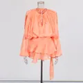 Elegant coral pink pleated mini dress featuring stylish bubble sleeves and a tiered ruffled hem - Light Orange