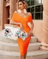 Detail view of vibrant orange off-shoulder bandage dress with tropical toucan print bags - XS / Top And Bottom / Orange