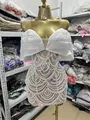 Detailed view of elegant white mini dress with intricate pearl beaded scalloped patterns - S / Tops / White