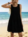 Fashionable sleeveless black tiered A-line summer dress with textured fabric on a beach - S / Dresses / Black