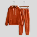 Athletic two-piece set featuring an orange hooded sweatshirt and matching joggers - Orange