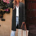 Detail of a charcoal grey cable-knit long cardigan with buttons and side pockets. - Dark Gray