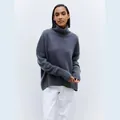 Detail shot of a soft dark grey turtleneck sweater with a cozy oversized fit. - Orchid Gray
