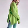 Side view of loose green turtleneck sweater with split hem and graphic detail - S / Tops / Grass Green
