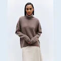 Close-up detail of a soft brown turtleneck pullover sweater showing its knit texture - Dark Brown