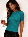Close-up of a women's vintage teal cable-knit short-sleeved top with a round neck. - Teal