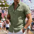 Close-up of men's olive green cotton shirt with utility chest pockets and white buttons. - S / Tops / Army Green