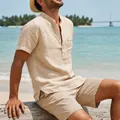 Close-up of a men's vintage short-sleeve linen beach shirt in a casual outdoor setting - Light Khaki