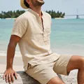 Close-up of a men's vintage short-sleeve linen beach shirt in a casual outdoor setting - Light Khaki