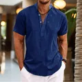 Close-up of a navy blue short-sleeved linen henley shirt with stand collar and button detail - Navy Blue