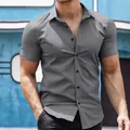 Close-up of a men's slim-fit short-sleeve shirt in charcoal grey with button details - Gray