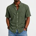 Close-up of olive green men's linen short sleeve shirt with standing collar and pocket - Army Green