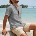 Side view of man wearing grey linen henley shirt on beach setting - S / Tops / Gray