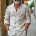 Close-up detail showing the double-breasted button arrangement on a beige linen shirt. - S / Tops / White