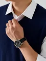 Close-up of navy blue V-neck knit sweater vest styled with a white shirt and watch - Navy Blue