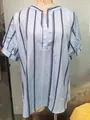 Detail of V-neck button closure on blue striped summer short sleeve blouse - 3XL / Tops / Sky Blue