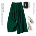 Close-up of elegant dark green cotton linen wide leg pants with loose fit and high waist - Dark Green