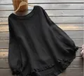 Detalle de una elegante camisa negra de algodón y lino con volantes en el bajo y puños - Negro