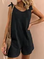 Detail view of a black linen-blend sleeveless romper with tie straps and pockets - S / Top And Bottom / Black