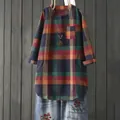 Detailed view of a vintage multi-color plaid long-sleeved tunic shirt in a loose fit. - S / Tops / Coffee Plaid