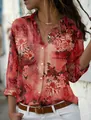 Detailed shot of women's red floral print long sleeve button-down shirt on model outdoors - 3XL / Tops / Orange Red Floral