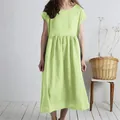 Detail view of a lime green pleated cotton linen maxi dress featuring a loose and casual fit - Light Green