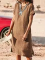 Casual brown short sleeve dress with side slits shown in a desert lifestyle setting. - Khaki