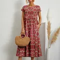 Detailed shot of a floral cotton-linen maxi dress paired with a stylish straw bag - S / Red Flower