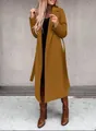 Full body view showcasing the silhouette and fit of the long belted mustard wool coat - Dark Brown