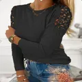 Detail of women's black long sleeve top with floral lace hollow-out shoulder design - S / Tops / Black
