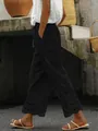 Detail view of women's black casual cropped pants with delicate lace eyelet hem - S / Bottoms / Black