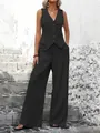 Full view of women's black vest suit set showcased on a model against a stone wall - S / Top And Bottom / Black