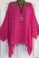 Close-up detail of vibrant fuchsia oversized blouse with irregular hem on mannequin - Rose Red