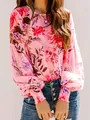 Close-up of women's pink floral long-sleeved blouse with smocked cuffs and round neck - S / Tops / Pink
