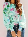 Close-up detail of a women's mint green blouse featuring a floral print and elegant smocked cuffs - S / Tops / Green