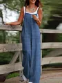 Detailed shot of woman in casual blue jumpsuit leaning against a rustic wooden outdoor fence - S / Top And Bottom / Blue Floral Print