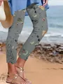 Close-up of floral women's cropped pants with lace patchwork detail on a beach - S / Bottoms / Gray
