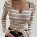 Close-up detail of a striped slim fit long sleeve knit top with a unique split neckline design. - S / Tops / Khaki