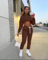 Fashionable woman wearing a brown two-piece cropped hoodie and jogger pants set on the street - M / Top And Bottom / Brown