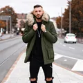 Detail of men's mid-length winter parka with a large faux fur collar in olive green. - S / Tops / Army Green