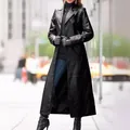 Detailed view of elegant women's long black leather trench coat in an urban street setting - S / Tops / Black