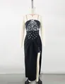 Detailed view of black evening gown with sparkling crystal bodice on mannequin - XS / Top And Bottom / Black