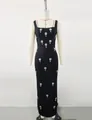 Detail view of black square neck bandage maxi dress with elegant rhinestone flower motifs - XL / Top And Bottom / Black