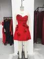 Detailed view of an elegant red strapless mini dress with 3D rose embellishments - S / Red