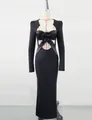 Detailed macro view of black evening bandage dress with feather and flower decor - S / Black