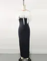 Detailed view of the large white floral applique on this elegant black bandage evening gown - XS / Black and White