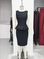 Detailed view of sophisticated black peplum knit top and bandage pencil skirt set on mannequin - XS / Top And Bottom / Black
