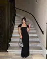 Elegant black long evening gown with a sparkling diamond neckline detail in a luxury setting - S / Black