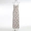 Detailed view of white floral hollow-out lace maxi dress on transparent mannequin for display - XS / Top And Bottom / Apricot White